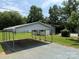A carport with a metal roof and supports provides convenient parking for vehicles at 6018 Unionville Rd, Monroe, NC 28110