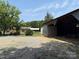 View of house with metal barn and shed, plus ample yard space at 6018 Unionville Rd, Monroe, NC 28110