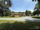 Spacious home with a gravel driveway and lush trees surrounding the property at 6018 Unionville Rd, Monroe, NC 28110
