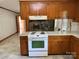 Kitchen view featuring an electric range with connecting views to an adjoining hearth room at 6018 Unionville Rd, Monroe, NC 28110