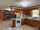Kitchen showing the electric range and view into the large hearth room at 6018 Unionville Rd, Monroe, NC 28110
