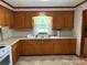 Traditional kitchen with wood cabinets, stainless steel sink, and a window view at 6018 Unionville Rd, Monroe, NC 28110