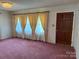 Bright living room filled with natural light from large windows, and original wood doors at 6018 Unionville Rd, Monroe, NC 28110