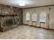Spacious living room with tile flooring, a stone fireplace, and lots of natural light at 6018 Unionville Rd, Monroe, NC 28110