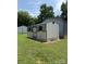 Small shed with lattice trim and door, plus trees around at 6018 Unionville Rd, Monroe, NC 28110