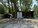 A large shed and a curved metal structure surrounded by mature trees at 6018 Unionville Rd, Monroe, NC 28110