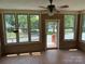 Bright sunroom with brick walls, tile floor and a ceiling fan at 6018 Unionville Rd, Monroe, NC 28110