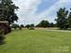 Expansive green front yard with established trees and views of open fields at 6018 Unionville Rd, Monroe, NC 28110