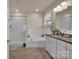 Bright bathroom with a soaking tub, walk-in shower, and granite countertops at 608 Latrobe Dr, Iron Station, NC 28080