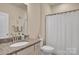 Cozy bathroom with granite countertop vanity and shower with white curtain at 608 Latrobe Dr, Iron Station, NC 28080