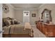 Bedroom with a comfortable bed and dresser decorated with flowers and a mirror at 608 Latrobe Dr, Iron Station, NC 28080