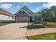 Charming home featuring stone accents, a two-car garage, and professionally landscaped front yard at 608 Latrobe Dr, Iron Station, NC 28080