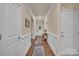 Hallway with hardwood floors, white walls, and decorative wainscoting at 608 Latrobe Dr, Iron Station, NC 28080