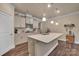 Bright kitchen featuring a center island, pendant lighting and stainless appliances at 608 Latrobe Dr, Iron Station, NC 28080