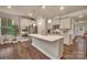 Bright kitchen featuring an island, stainless appliances, and wood-look flooring at 608 Latrobe Dr, Iron Station, NC 28080