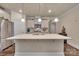 Spacious kitchen featuring a center island, stainless appliances and a white backsplash at 608 Latrobe Dr, Iron Station, NC 28080