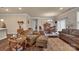 Open-concept living room with wood-look floors and view to dining room at 608 Latrobe Dr, Iron Station, NC 28080