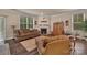 Comfortable living room featuring a fireplace, large windows and wood-look flooring at 608 Latrobe Dr, Iron Station, NC 28080