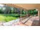 Spacious covered back porch with wood flooring, brick accents, and a view of the landscaped backyard at 616 26Th Nw St, Hickory, NC 28601