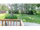 The backyard features lush greenery, a tree providing shade and a cozy firepit gathering area at 616 26Th Nw St, Hickory, NC 28601