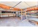 Spacious unfinished basement with utility connections, shelving, and concrete flooring at 616 26Th Nw St, Hickory, NC 28601