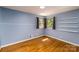 A bedroom with hardwood floors, two windows, and built-in wall shelves at 616 26Th Nw St, Hickory, NC 28601