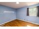 Cozy bedroom with hardwood floors features a decorative wall detail and a window at 616 26Th Nw St, Hickory, NC 28601