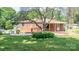 Charming brick home featuring a covered porch with a seating area and mature landscaping at 616 26Th Nw St, Hickory, NC 28601
