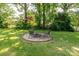 Outdoor fire pit area with chairs is perfect for entertaining in a lush, green backyard setting at 616 26Th Nw St, Hickory, NC 28601