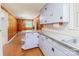 Functional kitchen area with ample cabinet and counter space, wood paneling, and access to dining area at 616 26Th Nw St, Hickory, NC 28601