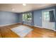 Bright living room with hardwood floors, blue walls, natural light, and a stylish area rug at 616 26Th Nw St, Hickory, NC 28601