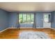 Spacious living room featuring hardwood floors, a large window, and a white door at 616 26Th Nw St, Hickory, NC 28601