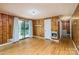 Charming living room features wood paneling, hardwood floors, and sliding glass doors to the porch at 616 26Th Nw St, Hickory, NC 28601