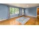 Bright living area with hardwood floors, blue walls, natural light, and a white door at 616 26Th Nw St, Hickory, NC 28601