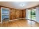 Inviting living room boasts hardwood floors, wood paneling, and a sliding door to a porch at 616 26Th Nw St, Hickory, NC 28601