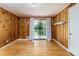 Bright living room with hardwood floors and wood paneling showcases natural light and access to the outdoors at 616 26Th Nw St, Hickory, NC 28601