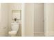 A half-bathroom with a toilet, small wall art, and natural light at 6295 Fairfax Ct, Maiden, NC 28650