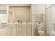 A modern bathroom with a double sink vanity, toilet, shower, and neutral decor at 6295 Fairfax Ct, Maiden, NC 28650