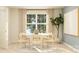 Elegant dining room with a round table, modern chairs, and a large window with natural light at 6295 Fairfax Ct, Maiden, NC 28650