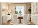 Elegant dining room featuring a round table, white chairs, modern chandelier and natural light at 6295 Fairfax Ct, Maiden, NC 28650