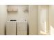 A laundry room featuring a washer, dryer, wire shelf and an open doorway at 6295 Fairfax Ct, Maiden, NC 28650