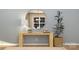 Modern living room featuring a console table, round mirror, table lamp and a plant on a carpeted floor at 6295 Fairfax Ct, Maiden, NC 28650