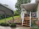 Charming back porch with covered area and stairs leading to a well-kept yard at 6300 Fox Hunt Rd, Indian Trail, NC 28079