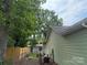 A fenced backyard featuring a shed, air conditioner, and wooded area at 6300 Fox Hunt Rd, Indian Trail, NC 28079