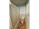 A quaint bathroom features a toilet, shower with a shower curtain and blue colored walls at 6300 Fox Hunt Rd, Indian Trail, NC 28079