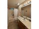 A bathroom with a shower-tub, toilet, sink, and large mirror at 6300 Fox Hunt Rd, Indian Trail, NC 28079