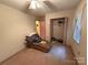 A bedroom features an open closet, chaise lounge, and window at 6300 Fox Hunt Rd, Indian Trail, NC 28079