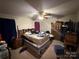 Primary bedroom features an armoire, ceiling fan, and carpeted floors at 6300 Fox Hunt Rd, Indian Trail, NC 28079