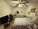 Cozy bedroom featuring carpeted floors, a comfortable bed, dresser, and natural lighting at 6300 Fox Hunt Rd, Indian Trail, NC 28079