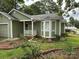 Charming single-story home with green siding, white trim, landscaped yard, and covered front porch at 6300 Fox Hunt Rd, Indian Trail, NC 28079